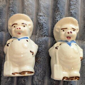 Ceramic salt and pepper shakers depicting farmer pigs